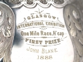 The inscription on the EE Mile Trophy